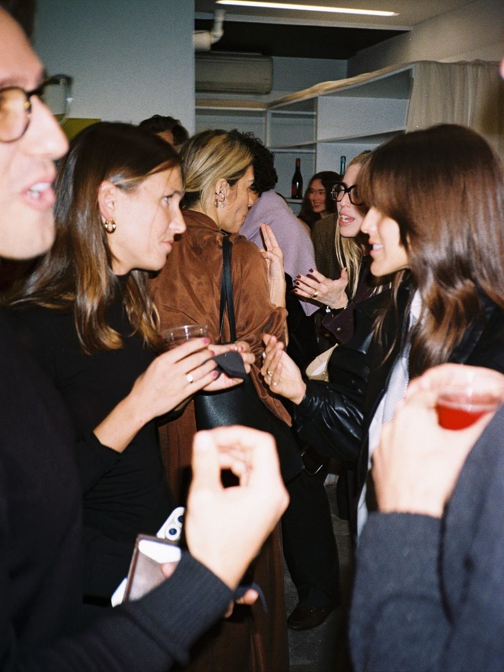 People talking at a busy launch event