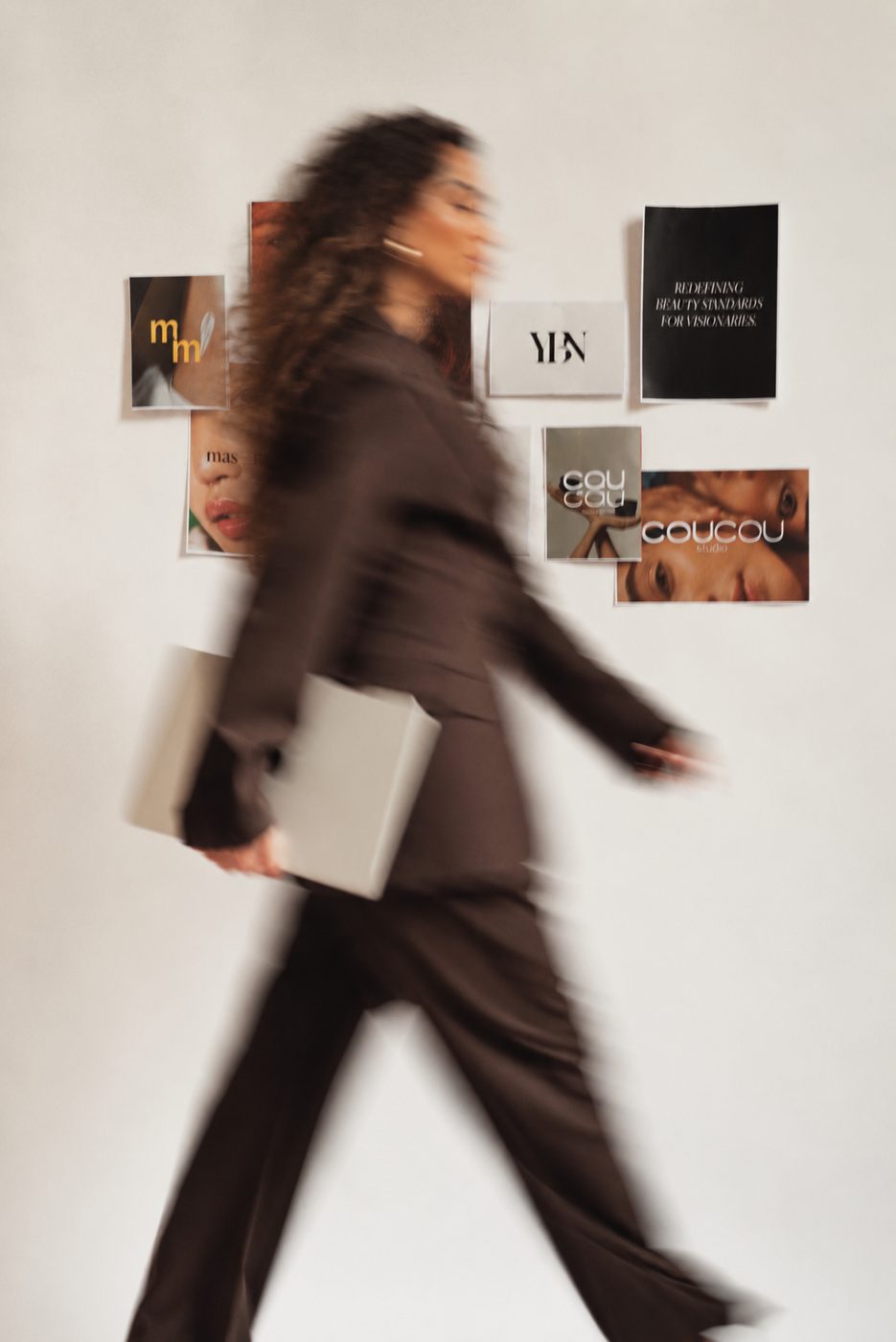 A wall of brand references, with someone walking past